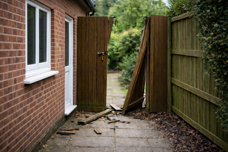 Image of a smashed side gate suggesting that someone has broken in
