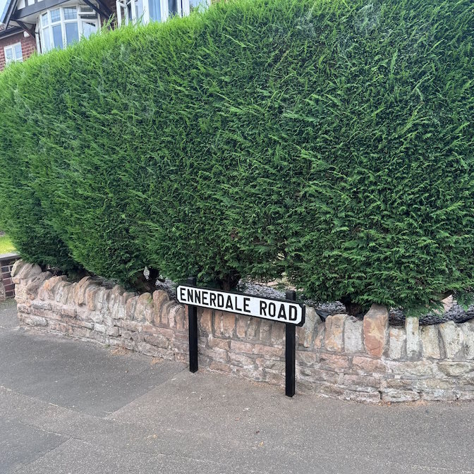 Photos of the Ennerdale Road sign after repainting